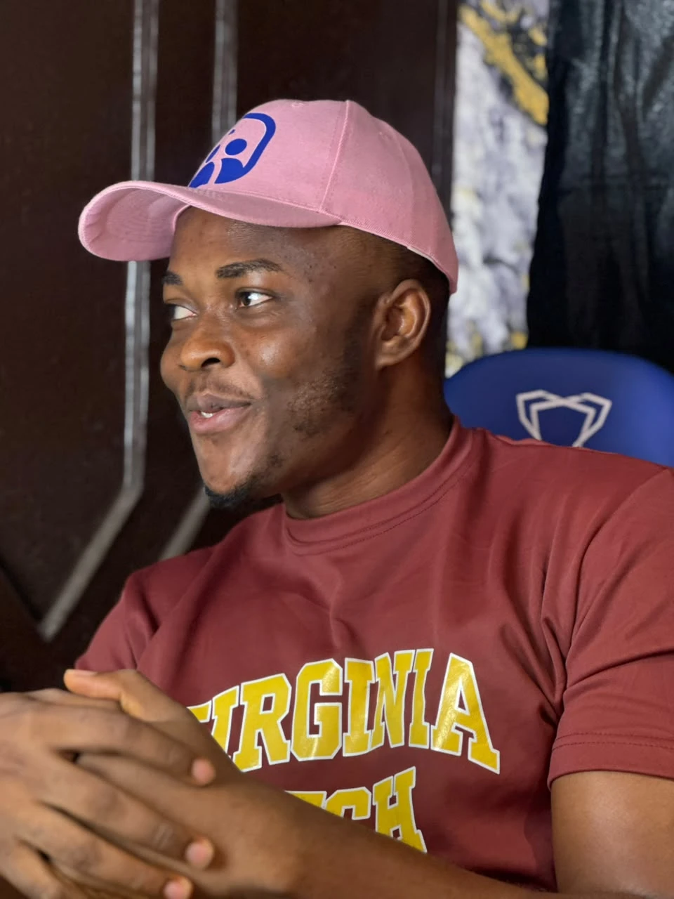 Godwin in a pink cap, smiling
