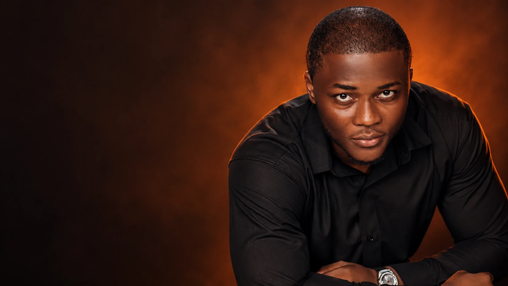 Godwin Ebube in warm orange studio light